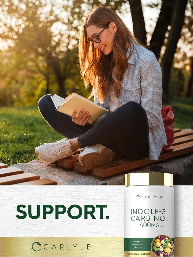A young woman reads outdoors next to an Indole-3-Carbinol supplement bottle.