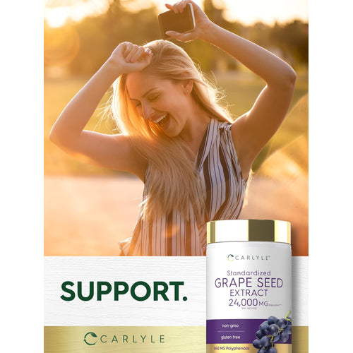 View 6 A young woman smiles and dances outdoors in sunlight, holding a Carlyle Grapeseed Extract bottle.