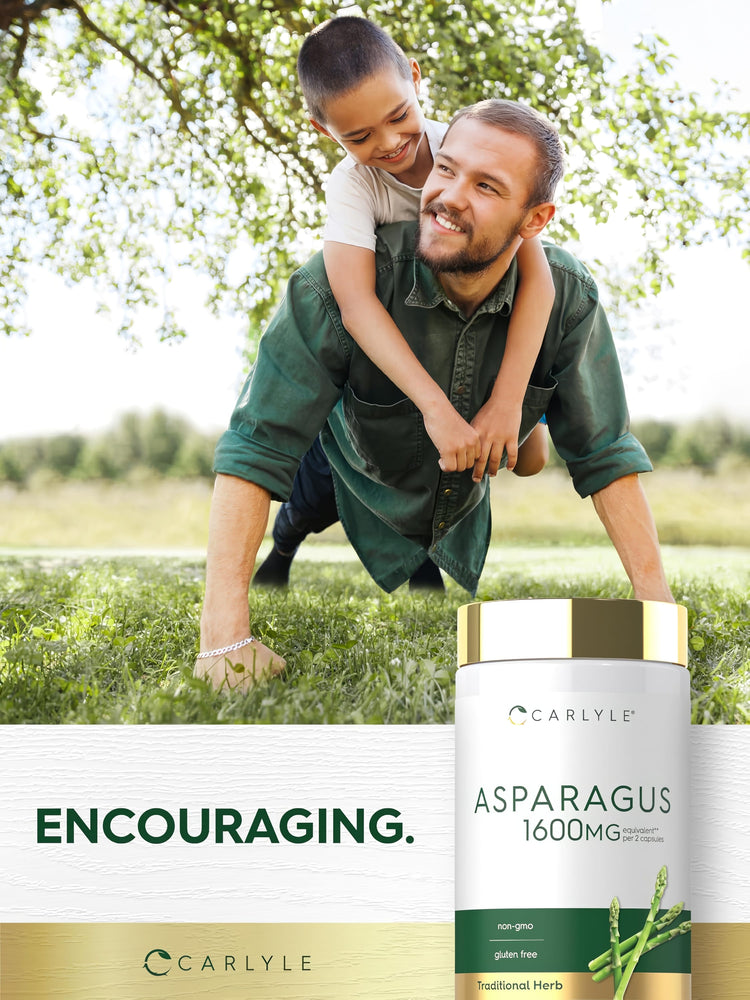 A man plays with a boy on his back in a grassy park, next to an Asparagus extract bottle.