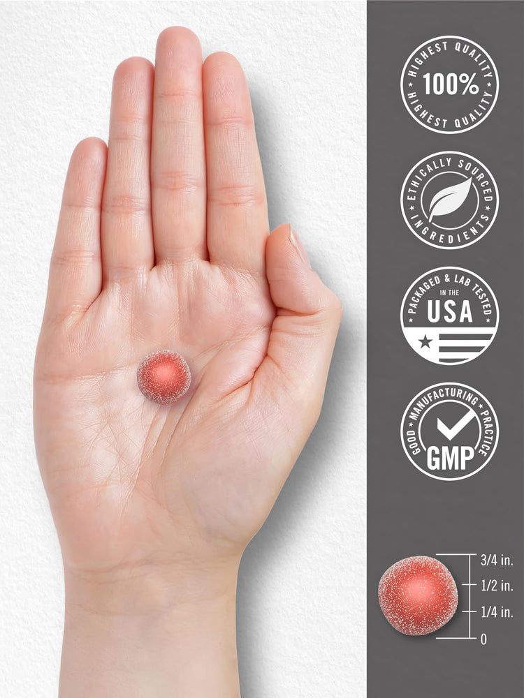 A single red, sugar-coated Magnesium gummy held in a hand, shown with a scale indicating it is three-fourths inch tall.