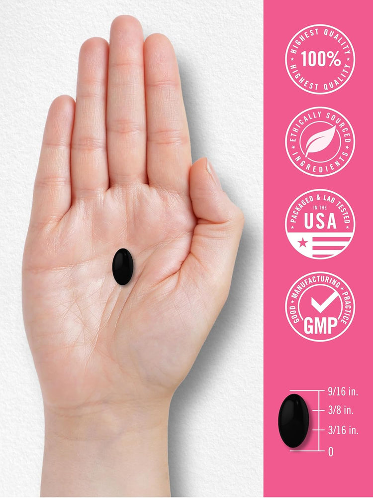 Carlyle Cranberry For Women black oval softgel in hand, measuring 9/16 in. long, 3/8 in. wide, 3/16 in. high.
