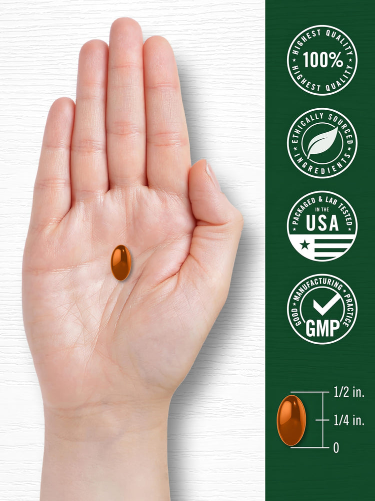 A hand holds an orange softgel capsule measuring 1/2 inch long and 1/4 inch wide.