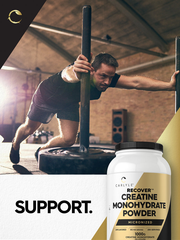 Middle-aged man in gym, leaning on a weight bar, with Carlyle Recover Creatine Monohydrate Powder jar nearby.