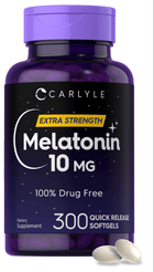 Two off-white 10 MG quick release softgels displayed on a hand scale in bulk for measurement or comparison.