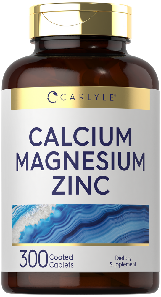 A hand holding Carlyle Calcium Magnesium Zinc 300 Coated Caplets bottle on a scale, showcasing the product's packaging and size.
