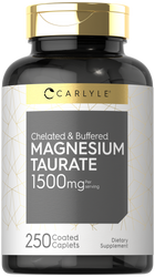 A hand holds a bottle of Carlyle Magnesium Taurate 1500mg, containing 250 coated caplets, emphasizing bulk purchase size.