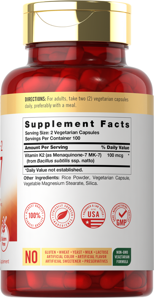 A red bottle of Vitamin K2 MK7 100 mcg vegetarian capsules on a hand scale.