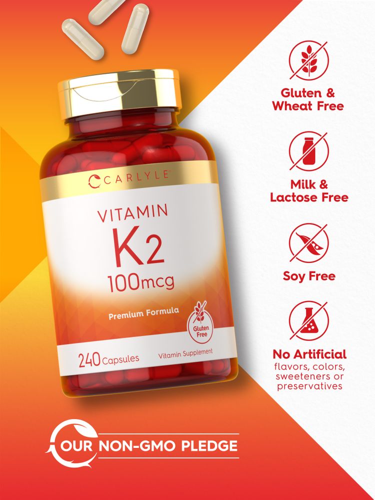 Hand holding Carlyle K2 100mcg capsules on a scale. Vitamin supplement shown in bulk with visible label and dosage.