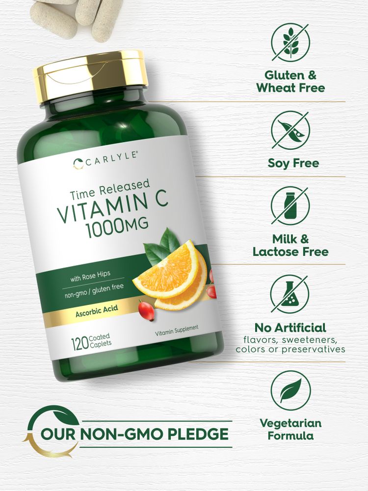 A hand holding several light beige, oval, coated 1000mg Vitamin C caplets.