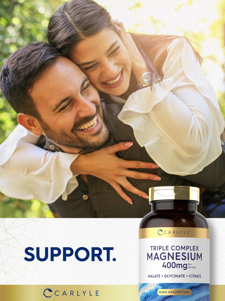 Young adult man and woman happily embracing outdoors with a bottle of Carlyle Triple Complex Magnesium in hand.