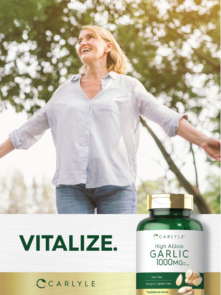 A middle-aged blonde woman smiles with arms outstretched outdoors. Text 'VITALIZE.' beside a Carlyle High Allicin Garlic 1000mg bottle.