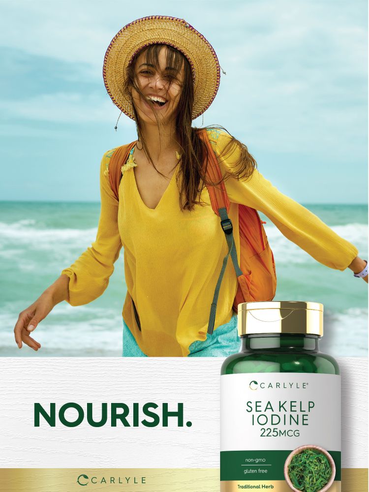 Woman laughing and walking on a beach beside a Carlyle Sea Kelp Iodine 225 mcg bottle.
