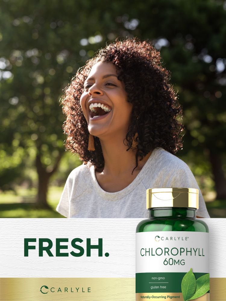 Carlyle Chlorophyll 60 mg capsules shown on a hand scale for size reference.