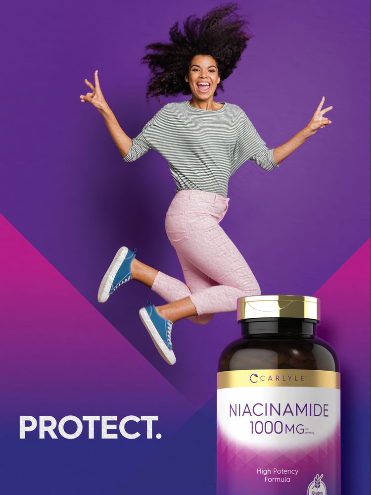 A young woman jumps and smiles, making peace signs, holding a bottle of Carlyle Niacinamide.