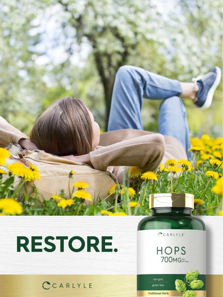 A young woman enjoys a field of dandelions while holding a Hops bottle.
