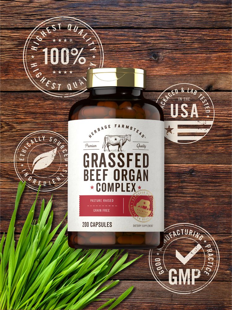 Hand holding a bottle of Grassfed Beef Organ Complex capsules, 650 mg each, 200 count, showcasing product size and detail.