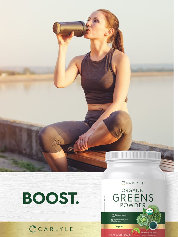 Carlyle Organic Greens Powder tub, Net Wt 2.2 lbs (1000 g), beside a woman drinking from a shaker bottle.