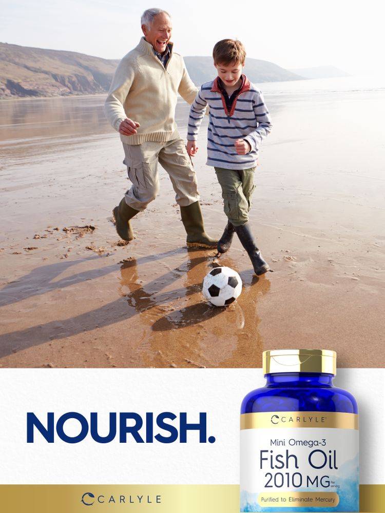 Older man and young boy playing soccer on a beach next to a Mini Omega-3 Fish Oil bottle.