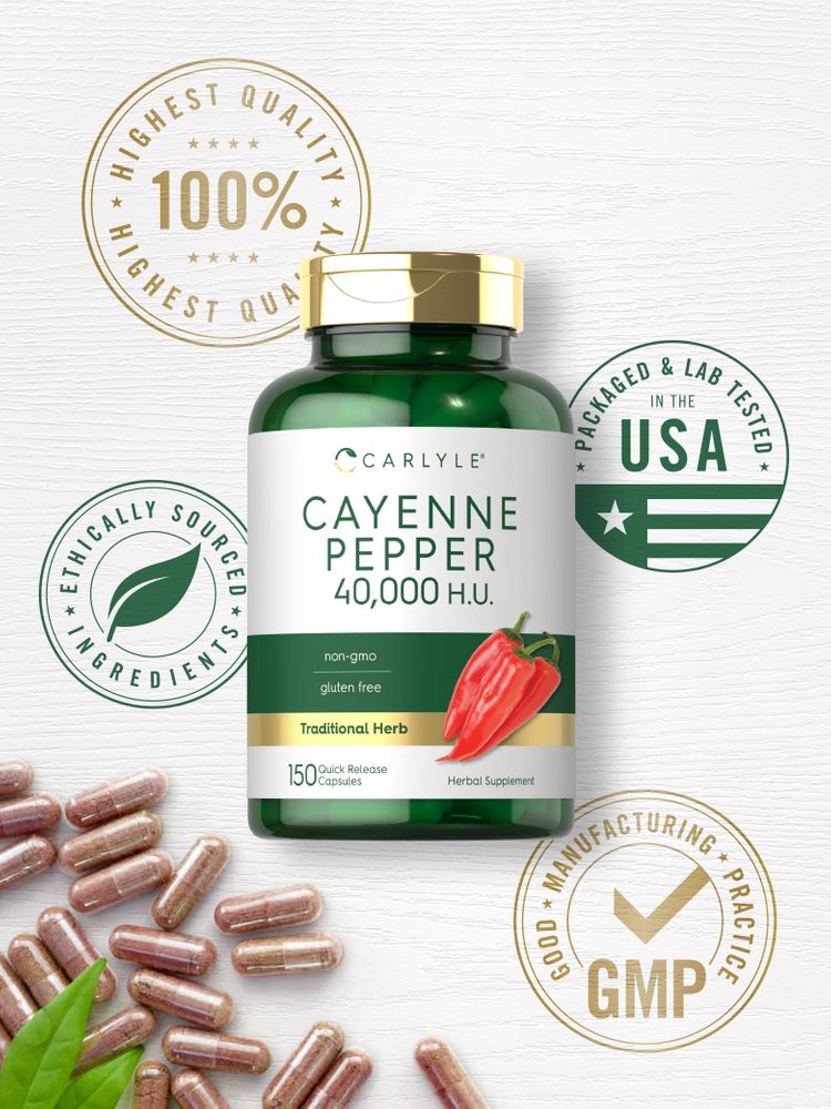 Carlyle Cayenne Pepper Quick Release Capsules scattered on a white background with green leaves nearby.