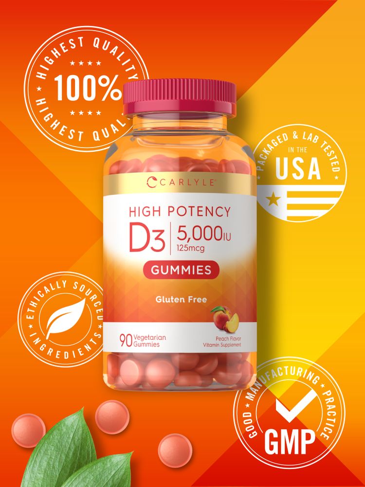 Peach-colored Carlyle Vitamin D 5000IU gummies displayed with green leaves on a scale.