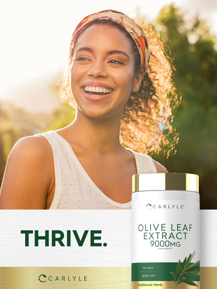 Young woman smiling outdoors holding a bottle of Olive Leaf Extract.