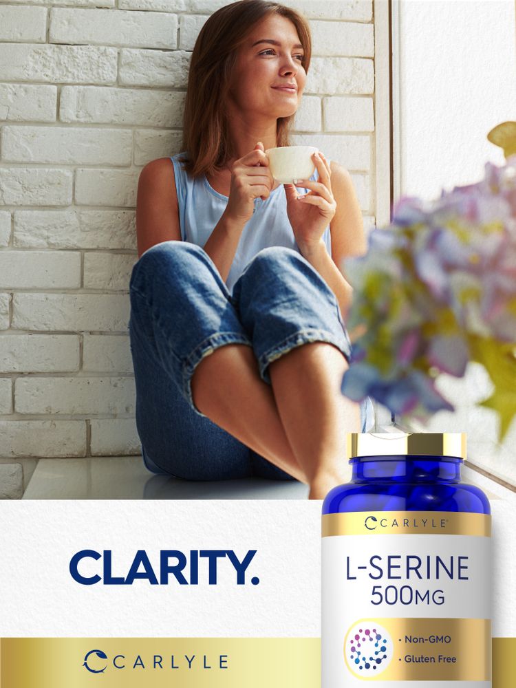 A young woman sits by a window holding a cup, looking out with a Carlyle L-Serine 500mg bottle nearby.