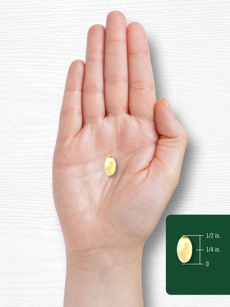 A yellow softgel rests on a hand, measuring half an inch long and a quarter inch wide.
