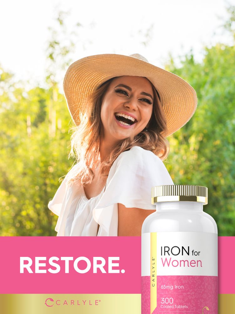 A young woman laughing outdoors next to a Carlyle Iron for Women bottle.