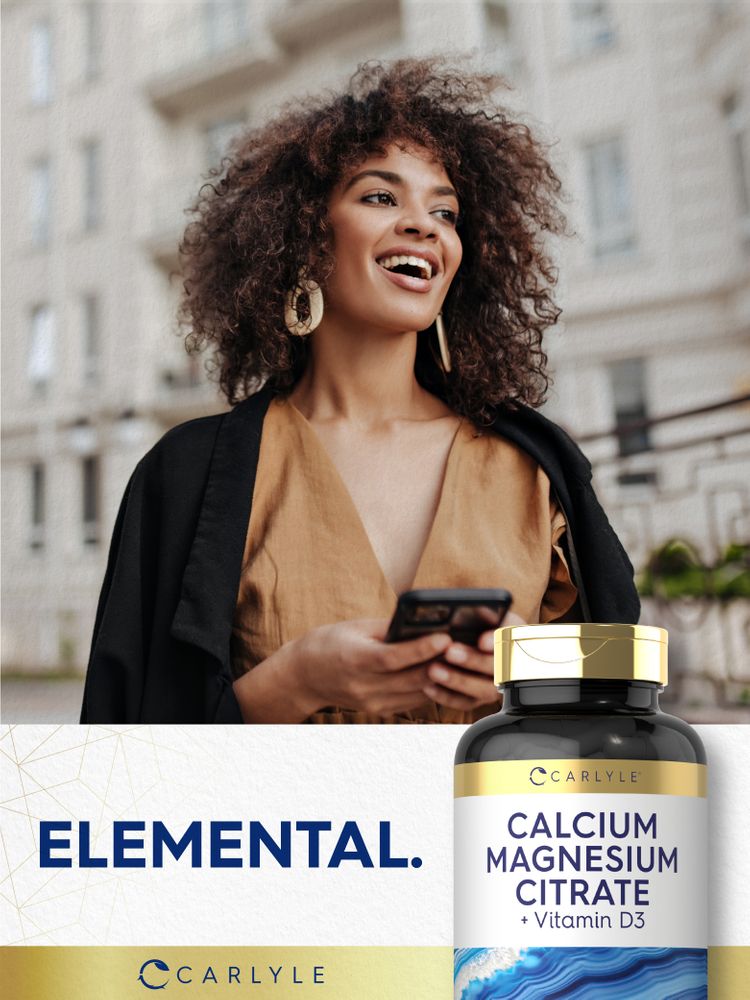 Smiling woman outdoors, holding a phone and a Carlyle Cal-Mag Citrate with D bottle.