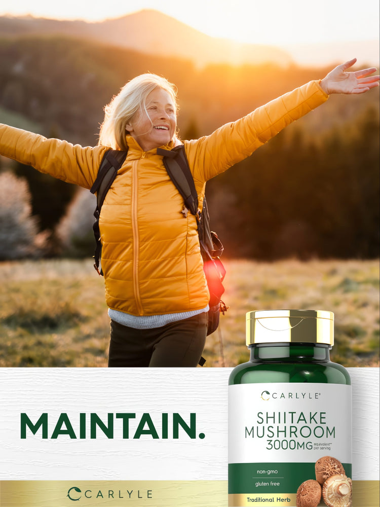 Older woman hiking with arms outstretched, smiling next to a Carlyle Shiitake Mushroom bottle.