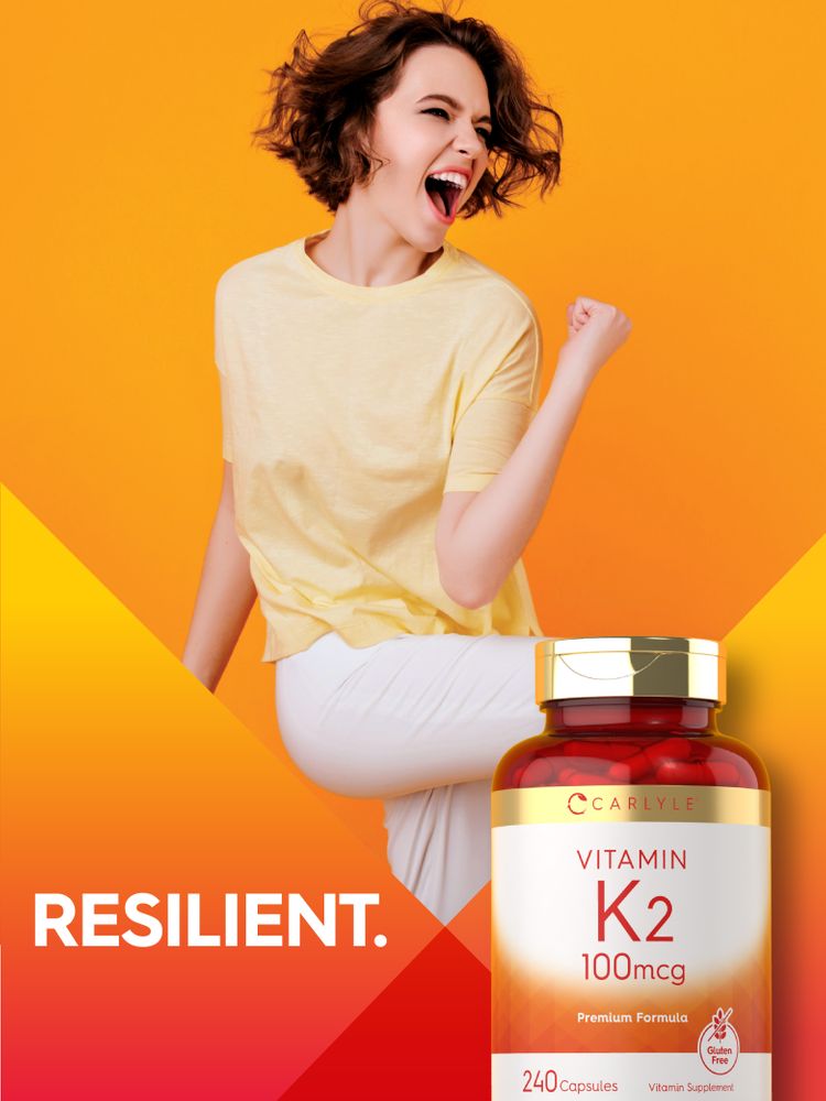 A hand holding Carlyle Vitamin K2 100mcg capsules, showing 240-count bottle for scale and size reference.