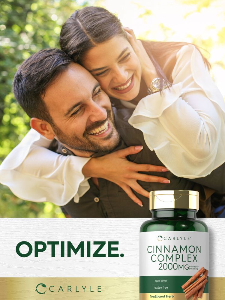 Young man gives piggyback ride to a laughing woman, both enjoying, with a bottle of Cinnamon Complex in view.