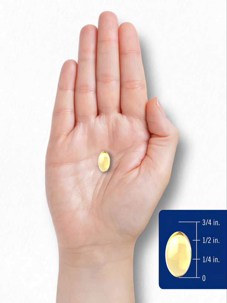 A yellow softgel in hand, measuring about 3/4 inch in length.