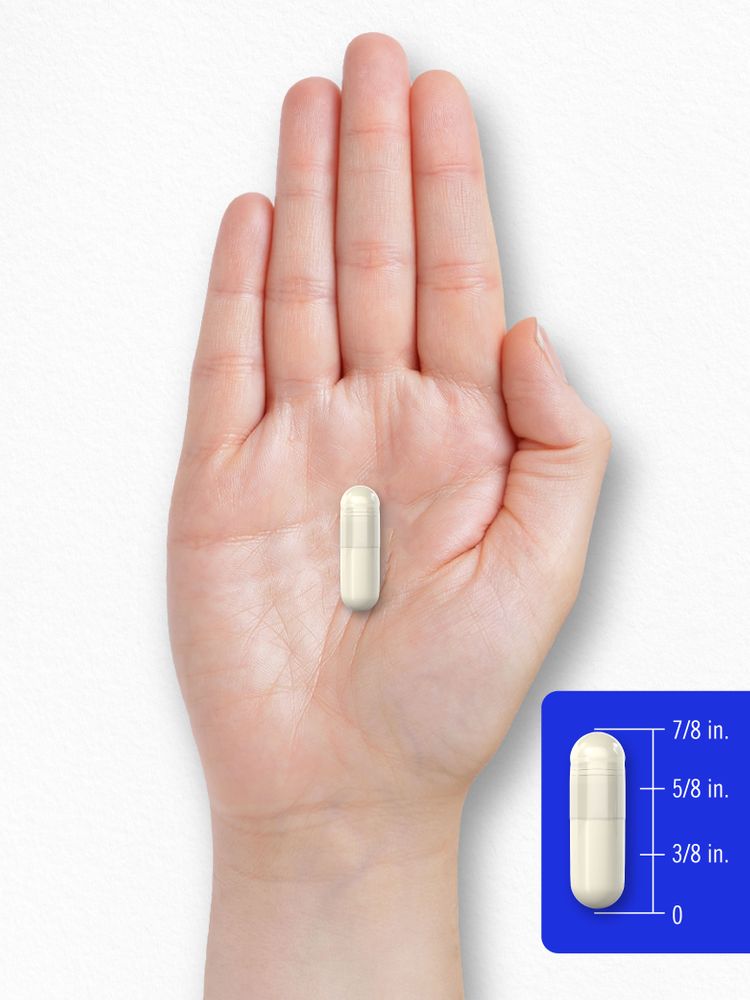 A hand holds a capsule that measures 5/8 inch long, suitable for bulk weighing or measuring purposes.