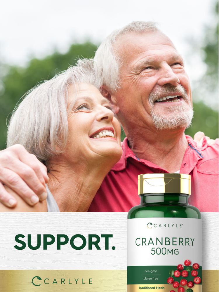 Senior couple smiling and hugging outdoors with a Carlyle Cranberry 500mg bottle visible.