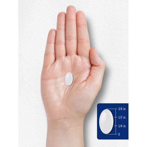 View 7 A 3/4 inch white oval softgel on a bulk scale, captured in hand scale view, emphasizing the softgel's size and shape.