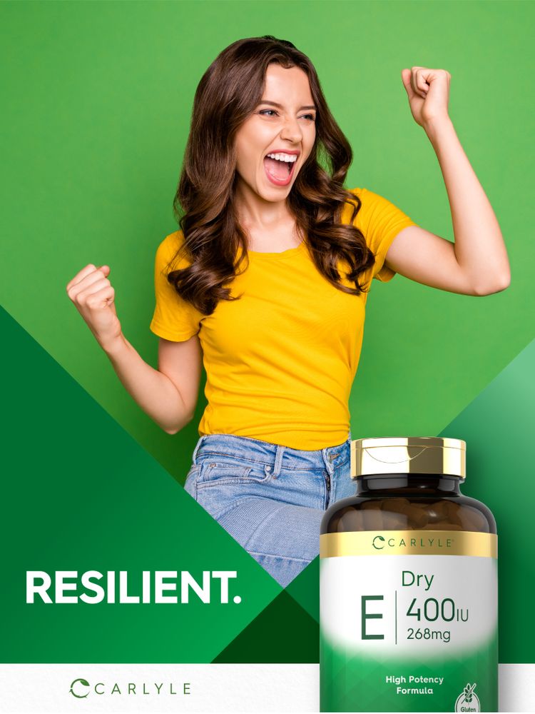 A young woman cheers enthusiastically next to a Carlyle Dry Vitamin E bottle.