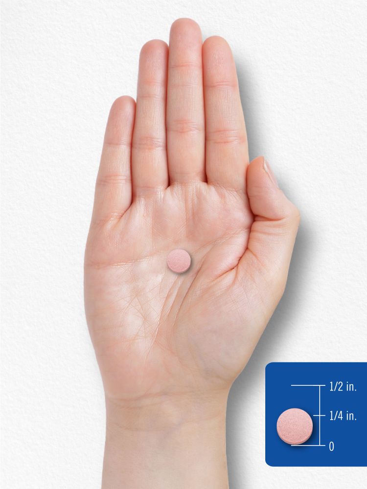 A pink round tablet on a scale, measuring 1/4 inch in diameter, highlighting its compact size for easy consumption or measurement.