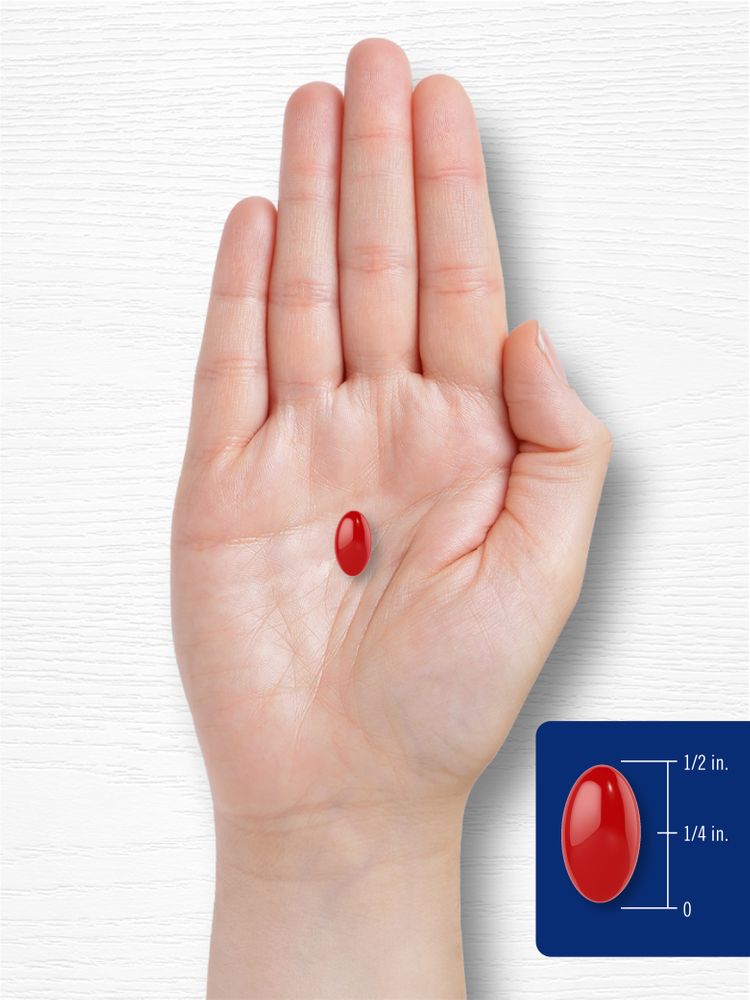 A red softgel, 1/2 inch long and 1/4 inch wide, rests on an open palm.