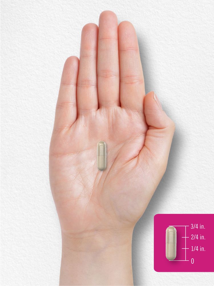 A light beige capsule, 3/4 inch long, is resting on an open palm.