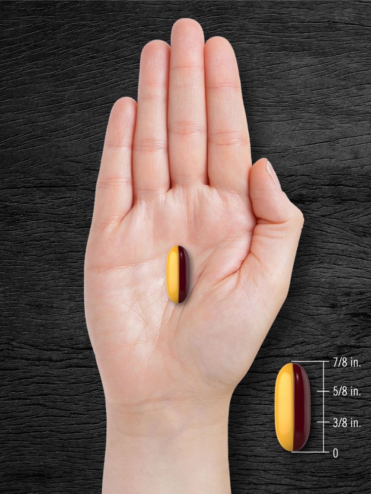 A yellow and maroon softgel measuring 7/8 inch in length is displayed on a bulk scale, showcasing its size and dimensions.