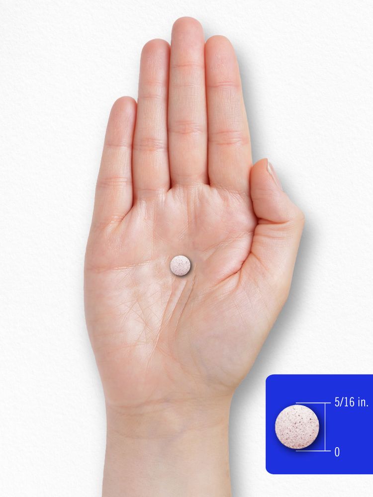 A round, light pink speckled tablet measures 5/16 inch in diameter.
