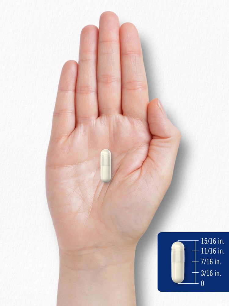 A capsule in a hand, measuring 11/16 inch in length.
