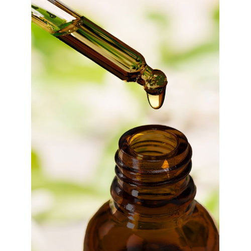 View 8 Liquid vitamin C drops from a glass dropper into a brown bottle.