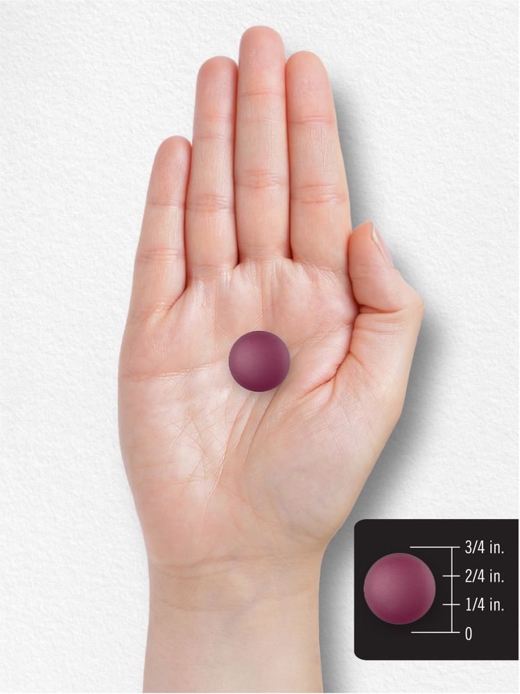 A purple gummy on a hand, measuring half an inch in diameter.