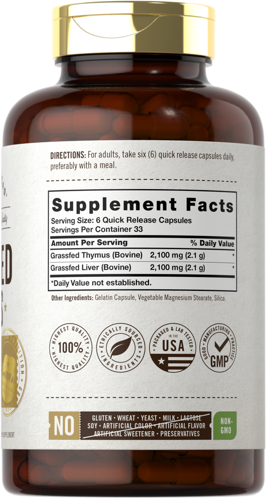 The image shows a hand holding a bottle of Grass Fed Thymus Extract 2100 mg Quick Release Capsules.