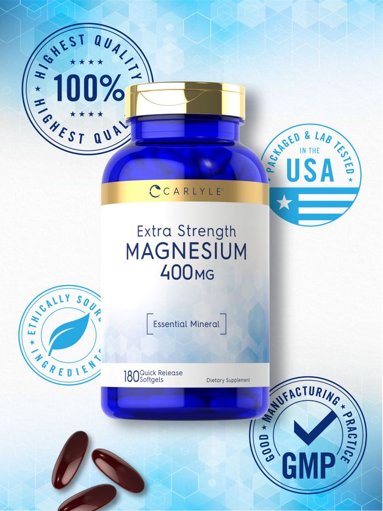 Three dark red softgels next to a bottle of Carlyle Extra Strength Magnesium 400MG, containing 180 quick release softgels.