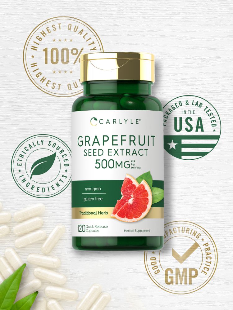 Hand holding loose white 500 mg quick release capsules on a bulk scale.