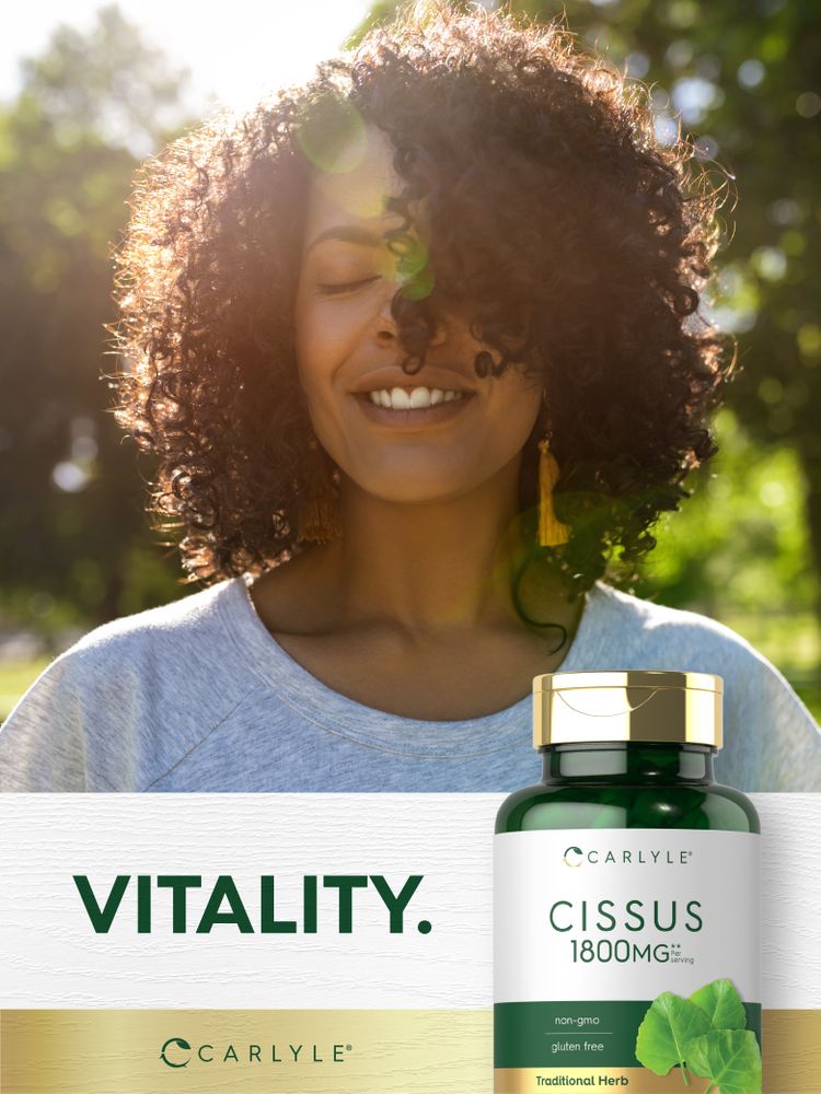 A smiling woman outdoors with closed eyes stands beside a green Carlyle Cissus 1800MG bottle labeled 'VITALITY.'