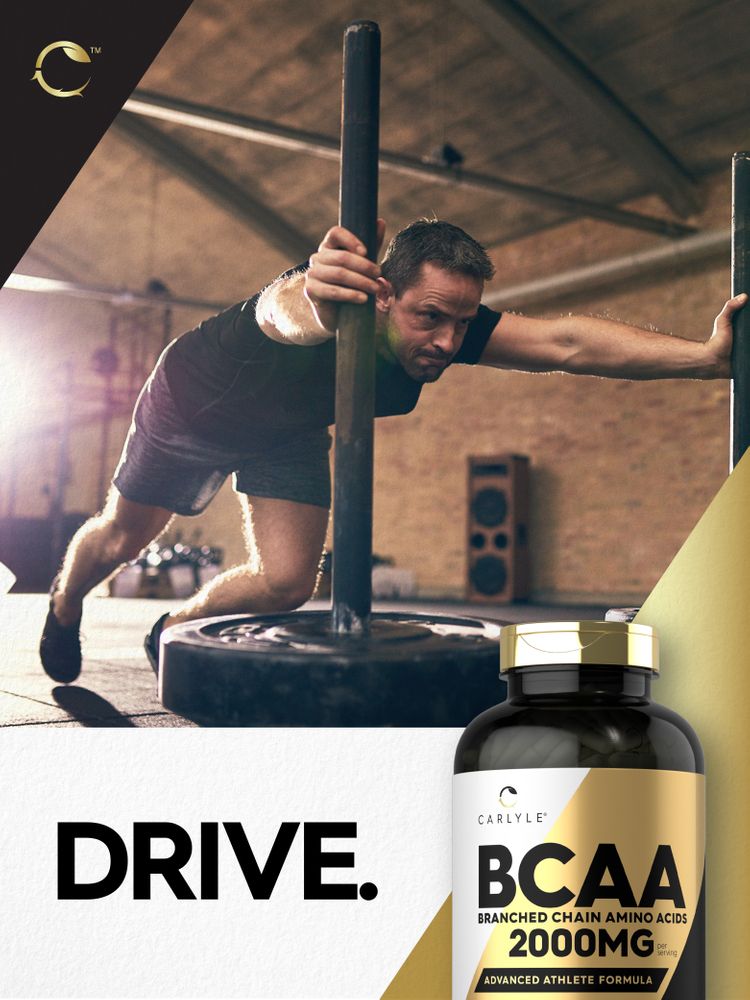 A hand holding a bottle of Carlyle BCAA 2000 mg capsules, showcasing their size and packaging in a close-up view.